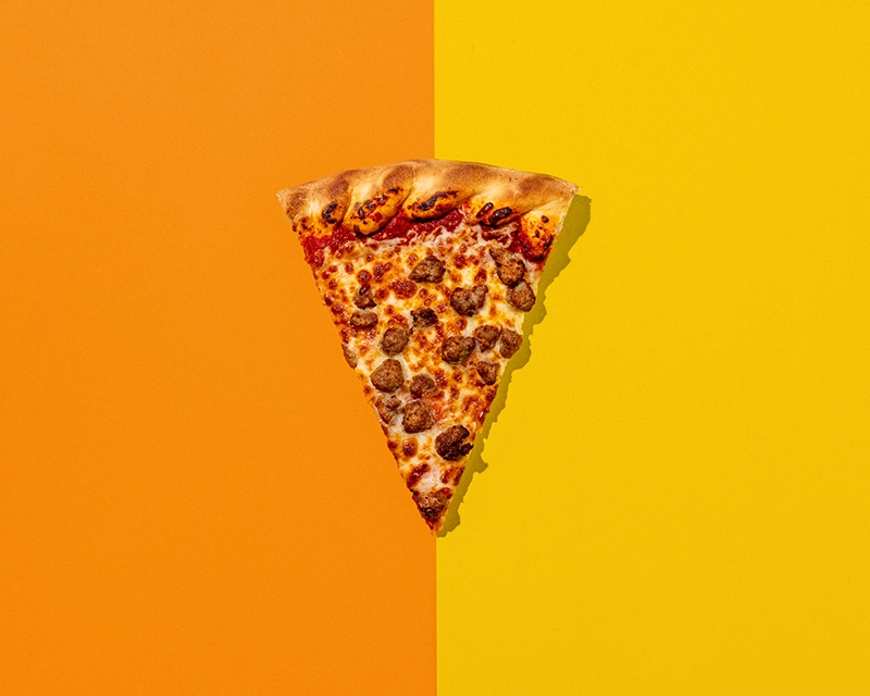 A slice of pizza on a colorful background at Holiday World & Splashin' Safari in Santa Claus, Indiana.