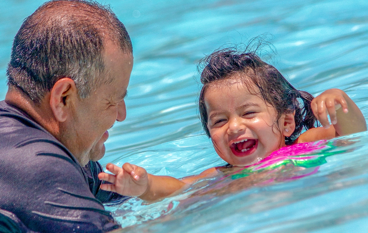 A grandfather and grand daughter smile and play in The Wave at Holiday World & Splashin' Safari in Santa Claus, Indiana.